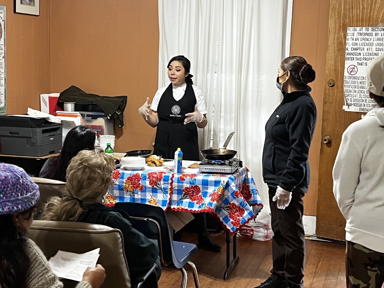 LDEISA Woman demonstrating a cooking technique to a class