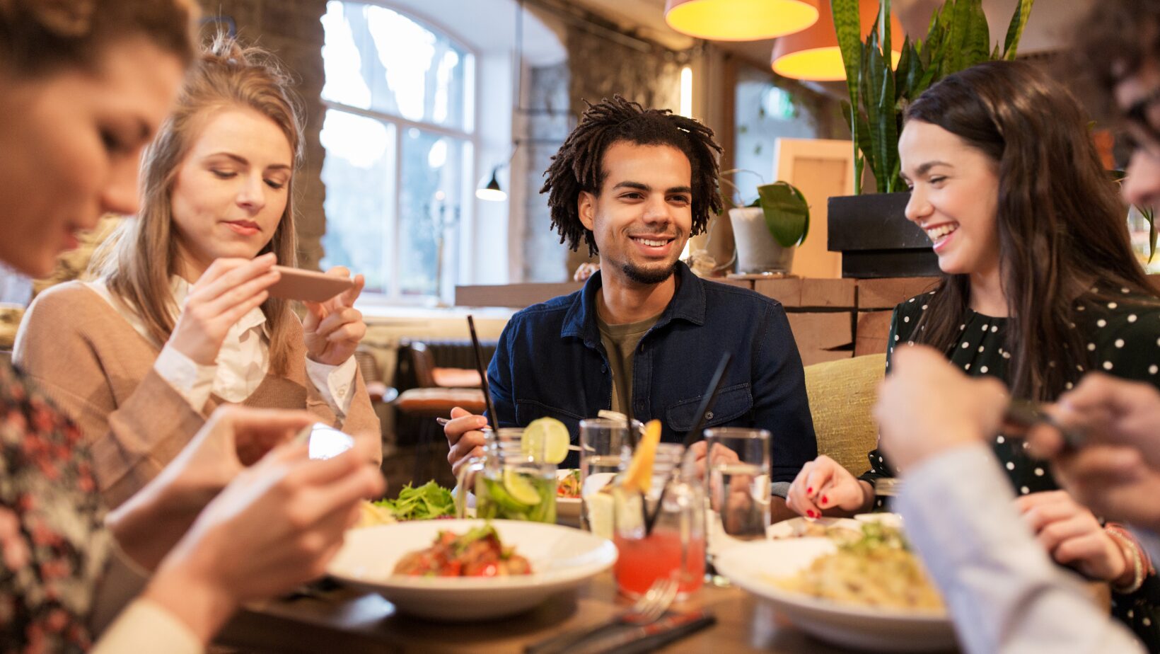 People at table eating Italian food People at table eating Italian food