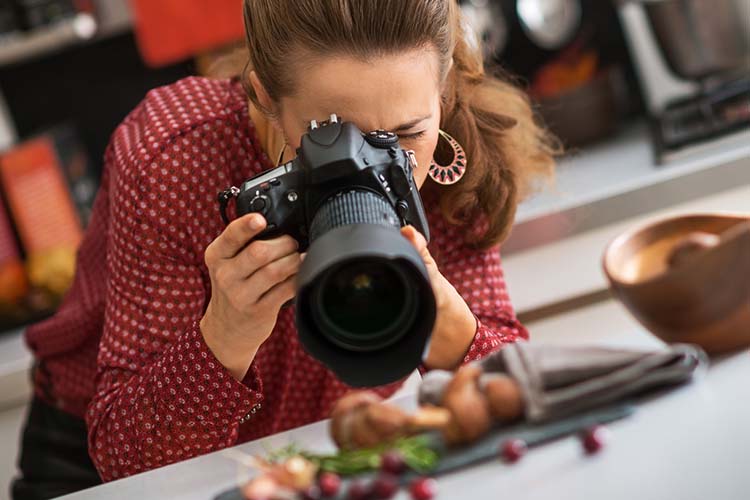 Photographer taking shots of food at restaurant for content creation story Photographer taking shots of food at restaurant for content creation story