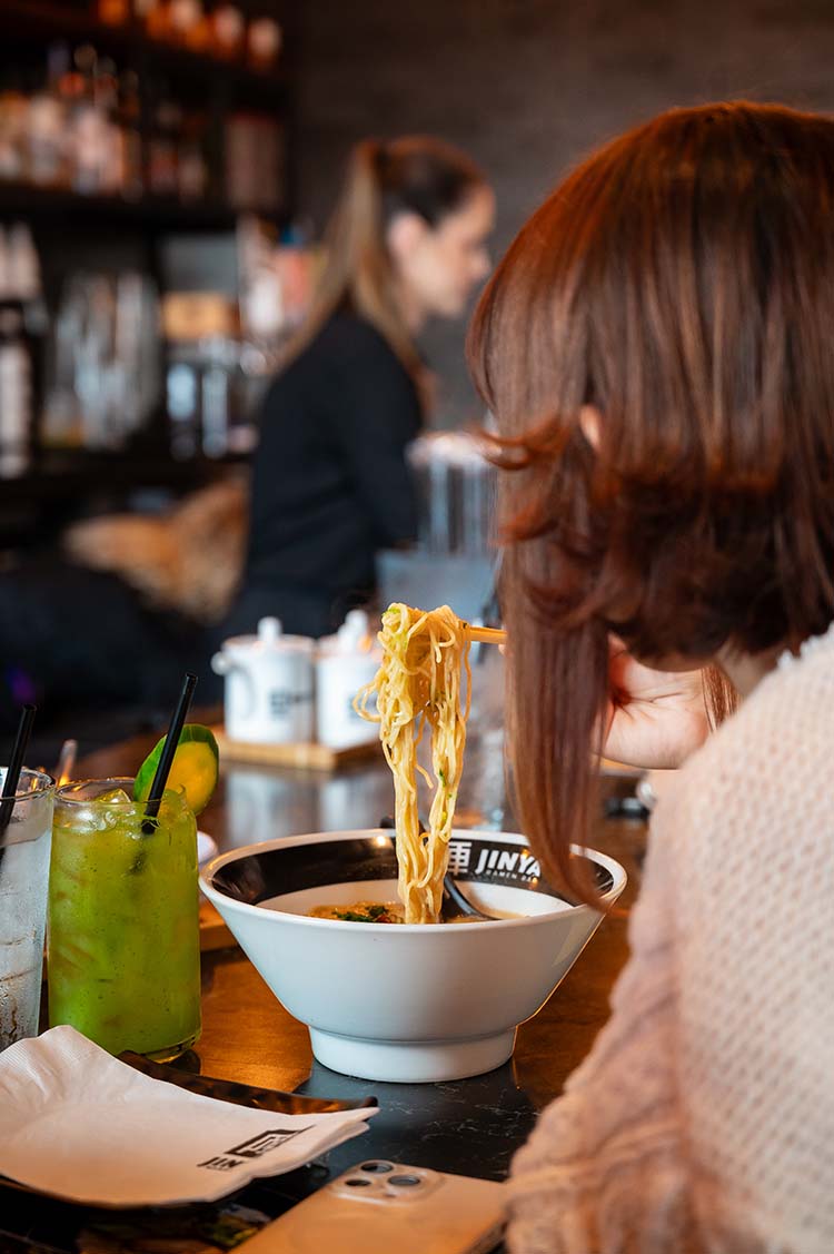 customer eating at Jinya Ramen Bar customer eating at Jinya Ramen Bar