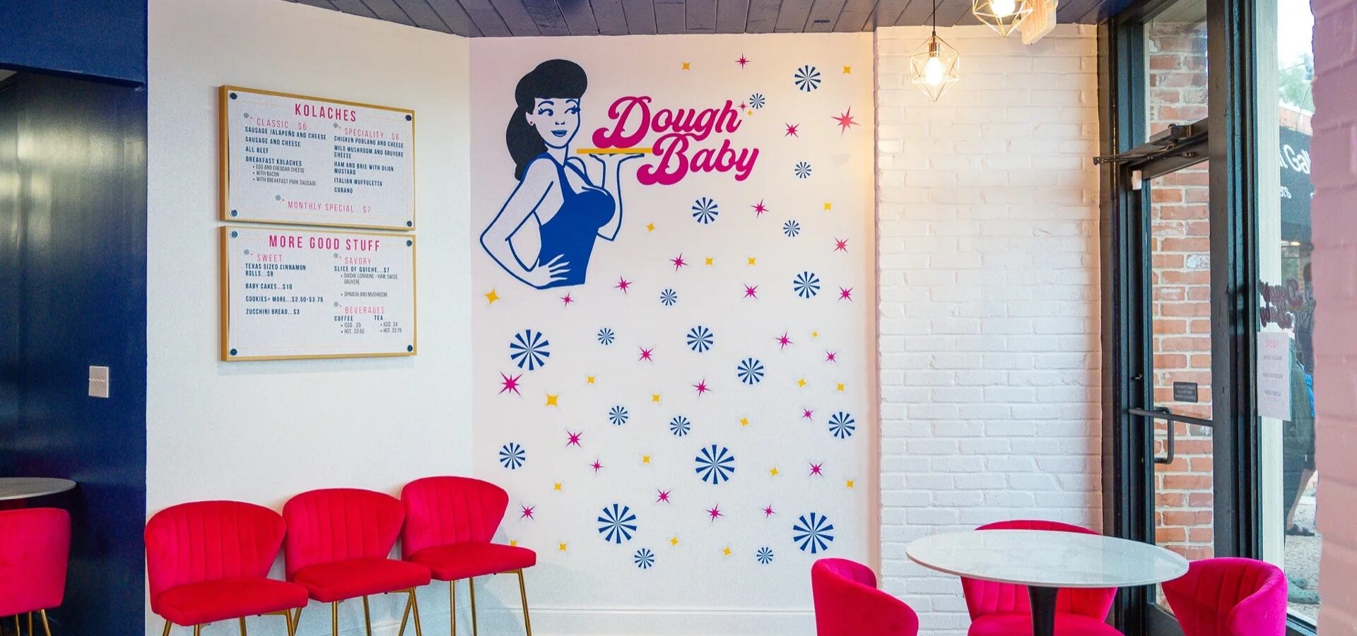 Dough Baby cafe interior with bright pink seating and bakery logo